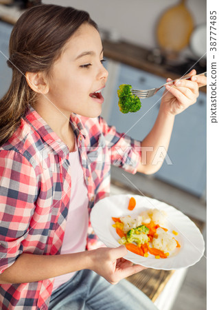 Inspired girl eating healthy vegetables for Inspired girl eating healthy vegetables for 38777485