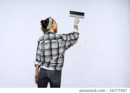 girl painterleveling the walls with a spatula,  38777487
