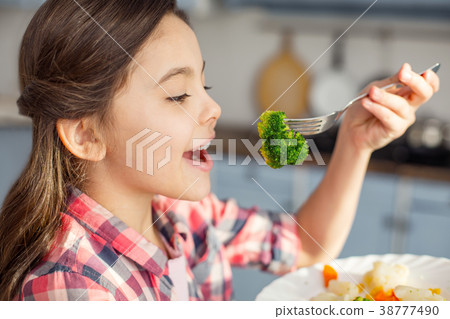 Content girl eating healthy vegetables for 38777490