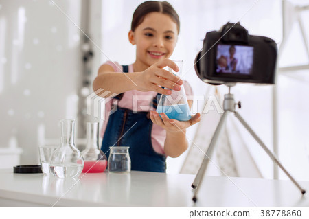 Joyful girl showing flask with blue chemical to Joyful girl showing flask with blue chemical to 38778860
