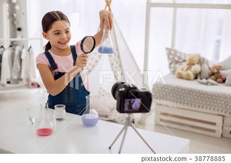 Cute girl examining result of chemical experiment 38778885