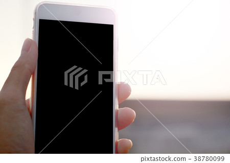 Hand holding phone isolated on black clipping 38780099