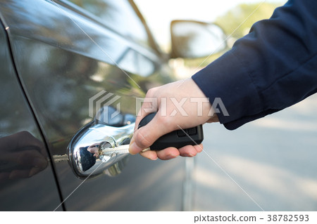 Female opening a car door by key Female opening a car door by key 38782593