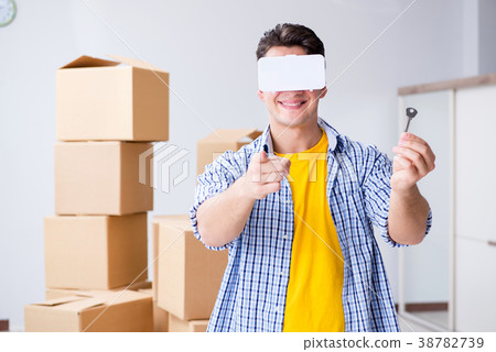 Young man wearing VR glasses moving in new 38782739