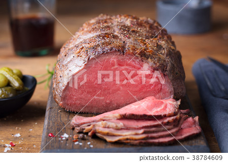 Roast beef on cutting board. Wooden background. 38784609