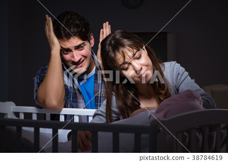 Young parents sleepless with newborn baby at night Young parents sleepless with newborn baby at night 38784619
