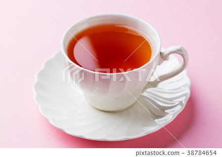Tea in white cup on pink background. Close up. Tea in white cup on pink background. Close up. 38784654