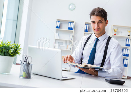 Young stylish businessman working in the office Young stylish businessman working in the office 38784803