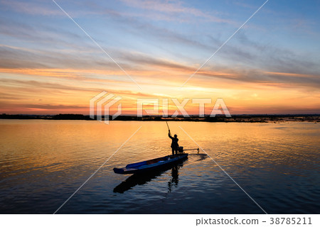 fisherman on long tail boat in the lake 38785211