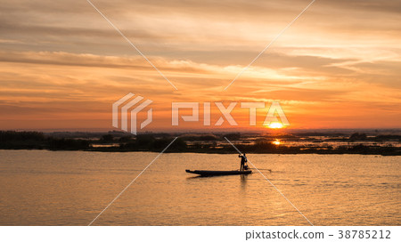 fisherman on long tail boat in the lake 38785212