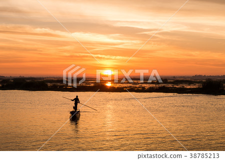 fisherman on long tail boat in the lake 38785213
