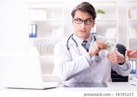 Doctor in corruption concept with being offered 38785225