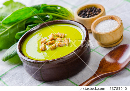 Spinach soup served on wooden board  38785940