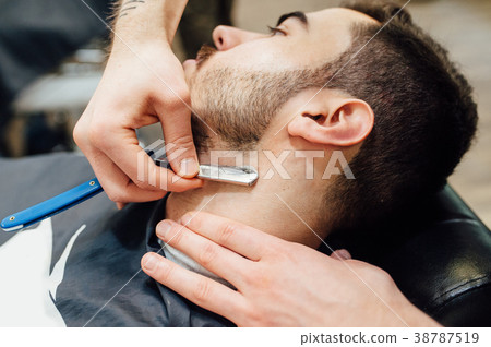 Barber shave and modeling beard at the hair salon 38787519