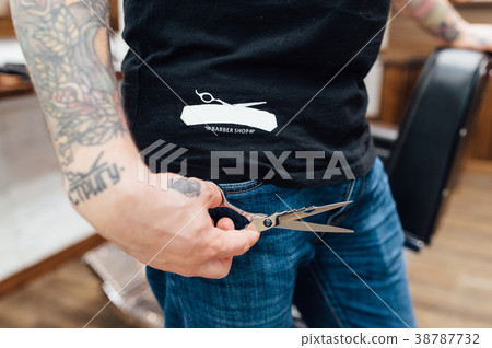barber man holds scissors 38787732