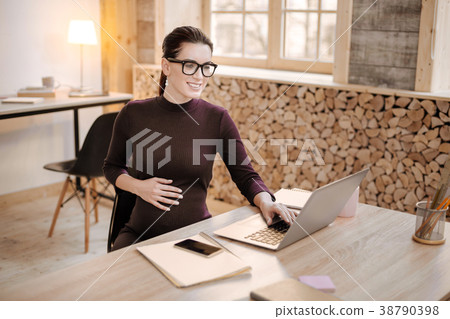 Skillful pregnant businesswoman preparing document Skillful pregnant businesswoman preparing document 38790398