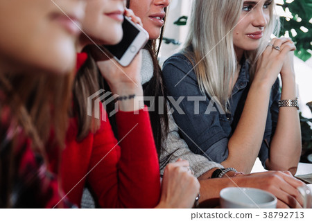 Side view of a Four smiling friends sitting by the Side view of a Four smiling friends sitting by the 38792713