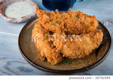 Crispy chicken tenderloid deep fried. 38792894