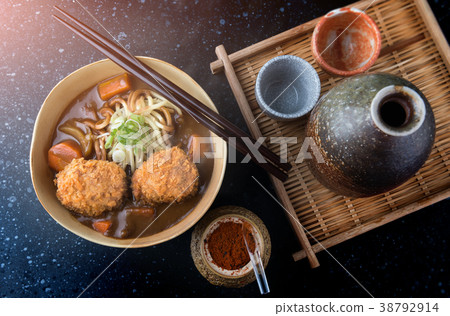 Japanese curry with udon and croquettes topping. 38792914