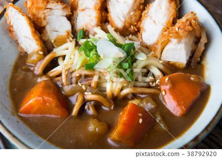 Japanese curry with udon and croquettes topping. Japanese curry with udon and croquettes topping. 38792920