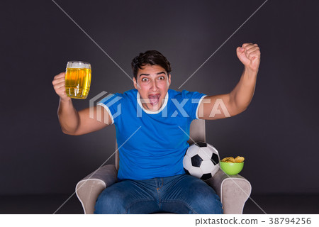 Man watching sports on gray background Man watching sports on gray background 38794256
