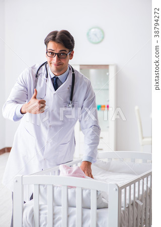 Man male pediatrician near baby bed preparing to 38794272