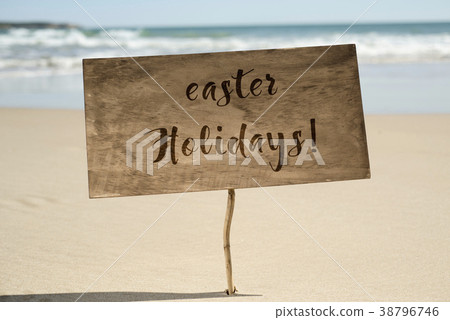 text easter holidays in a signboard on the beach text easter holidays in a signboard on the beach 38796746