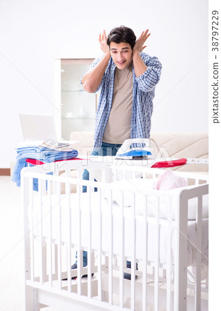 Young dad looking after newborn baby 38797229
