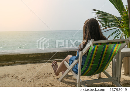 woman sitting and relax on deckchair in vacation 38798049