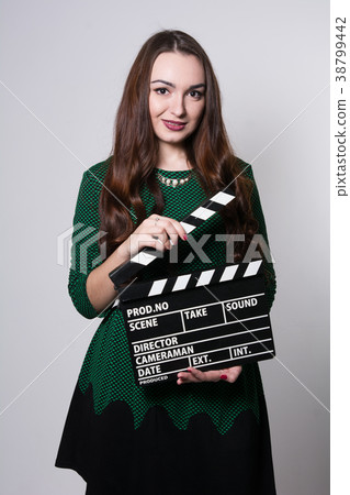 Young woman holding a movie clapper 38799442