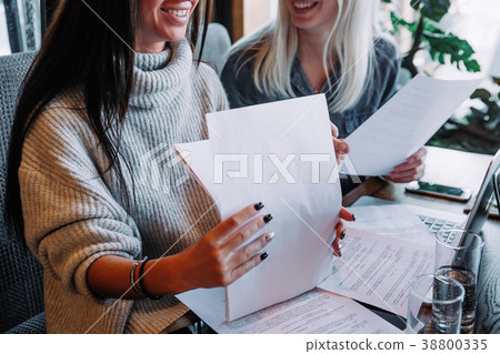 businesswoman signs a contract in a cafe at a businesswoman signs a contract in a cafe at a 38800335