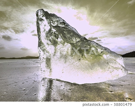 Broken piece of ice with sharp cracks inside. Broken piece of ice with sharp cracks inside. 38801479