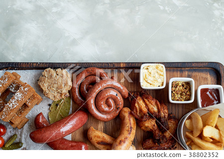 Meat set for a large company on a wooden stand Meat set for a large company on a wooden stand 38802352