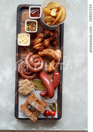 Meat set for a large company on a wooden stand Meat set for a large company on a wooden stand 38802354