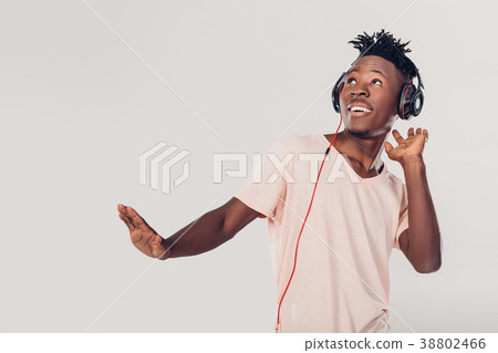 African-American man in headphones listening to 38802466