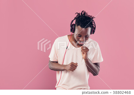 African-American man in headphones listening to 38802468
