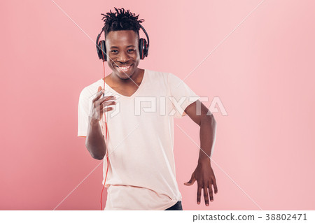 African-American man in headphones listening to 38802471