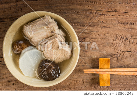 pork rib clear soup in a black ceramic bowl 38803242