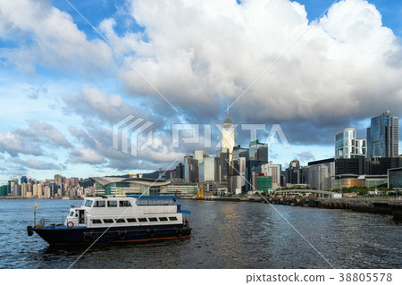 Scene of Hong Kong Cityscape river side in the afternoon with transportation boat and smooth cloud, presented the modern construction concept Scene of Hong Kong Cityscape river side in the afternoon with transportation boat and smooth cloud, presented the modern construction concept 38805578