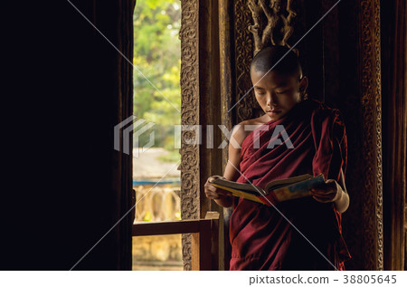 Closeup Buddhist novice reading at Shwenandaw pagoda, mandalay, myanmar 38805645