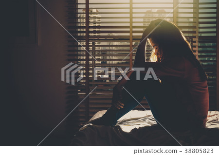 depressed Women sitting head in hands on the bed in the dark bedroom with low light environment, dramatic concept depressed Women sitting head in hands on the bed in the dark bedroom with low light environment, dramatic concept 38805823