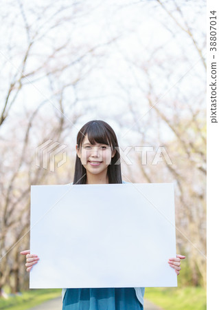 A young lady with a message board in the park Spring 38807014