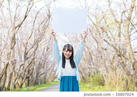 A young lady with a message board in the park Spring 38807024