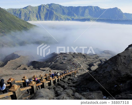 Tourists climb the stairs to the Bromo Mountain Crater in the background of the sea of clouds (Bromo Tengel Semeru National Park) Indonesia 38807318