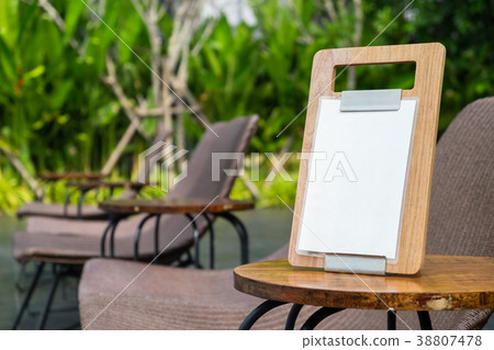 Empty menu frame standing on wood table  38807478