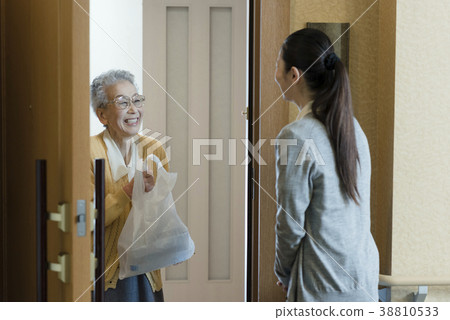 Senior woman receiving food from home helper 38810533