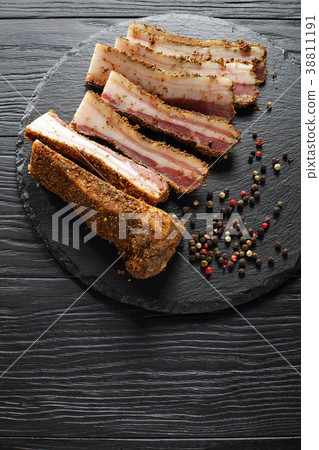 piced smoked speck cut in slices piced smoked speck cut in slices 38811191