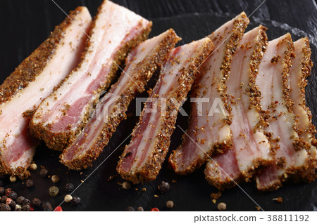 smoked speck cut in slices, close-up 38811192