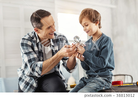 Joyful father showing his instruments to his son Joyful father showing his instruments to his son 38813012