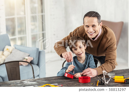 Exuberant boy learning how to use instruments Exuberant boy learning how to use instruments 38813297